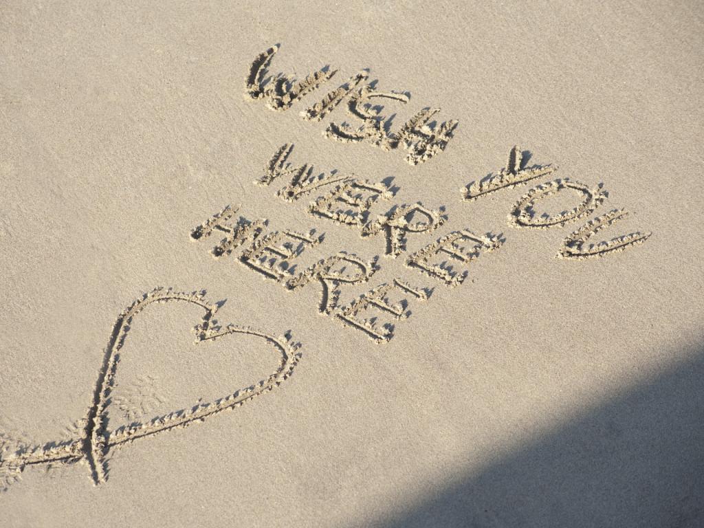 Wish You Were Here on beach sand
